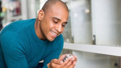 A person wearing blue tshirt holding hamster